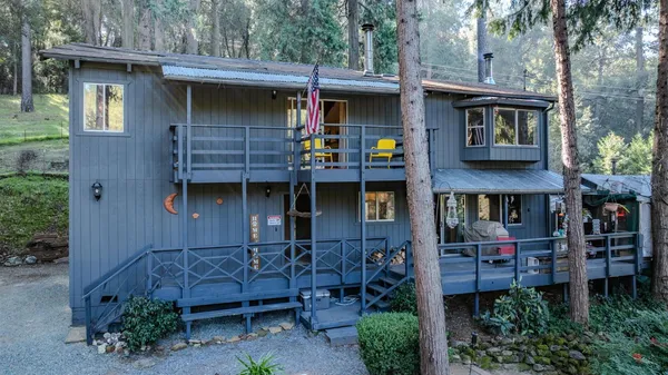 a front view of a house with plants