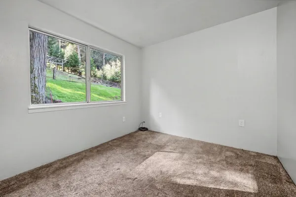 a view of a patio with table and chairs with wooden floor and fence
