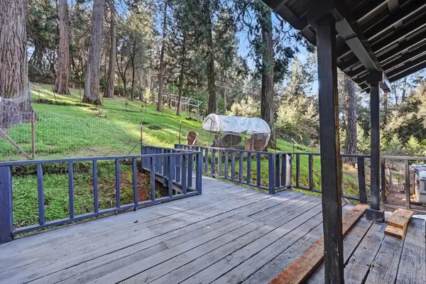 a view of house with roof deck and seating space