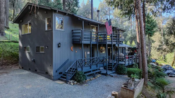 a view of a house with balcony and trees