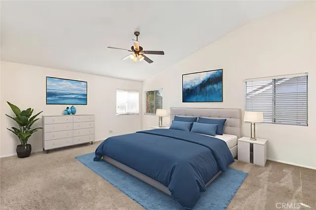 a bedroom with a large bed a potted plant and a window