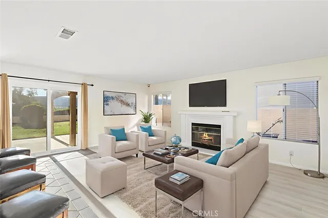 a living room with furniture a fireplace with city view