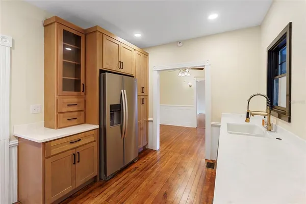 a kitchen with stainless steel appliances a refrigerator sink and cabinets