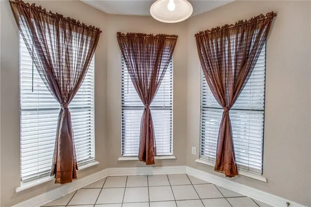 an entryway with a flower pot and a window