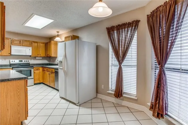 a kitchen with stainless steel appliances granite countertop a refrigerator and a stove