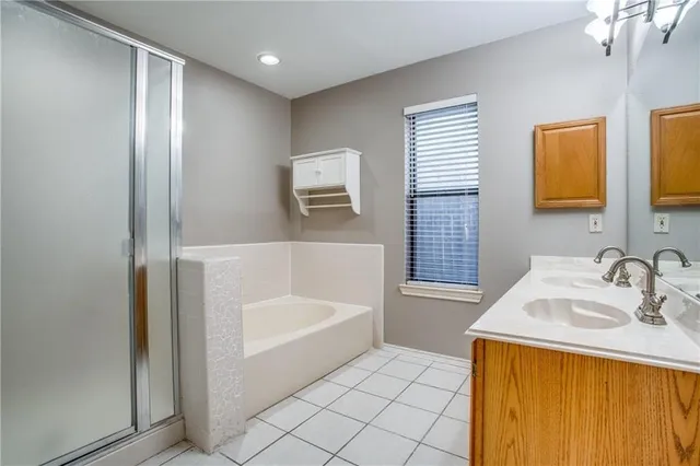 a bathroom with a tub sink and mirror