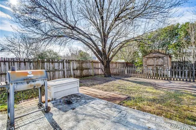 a view of street with wooden fence