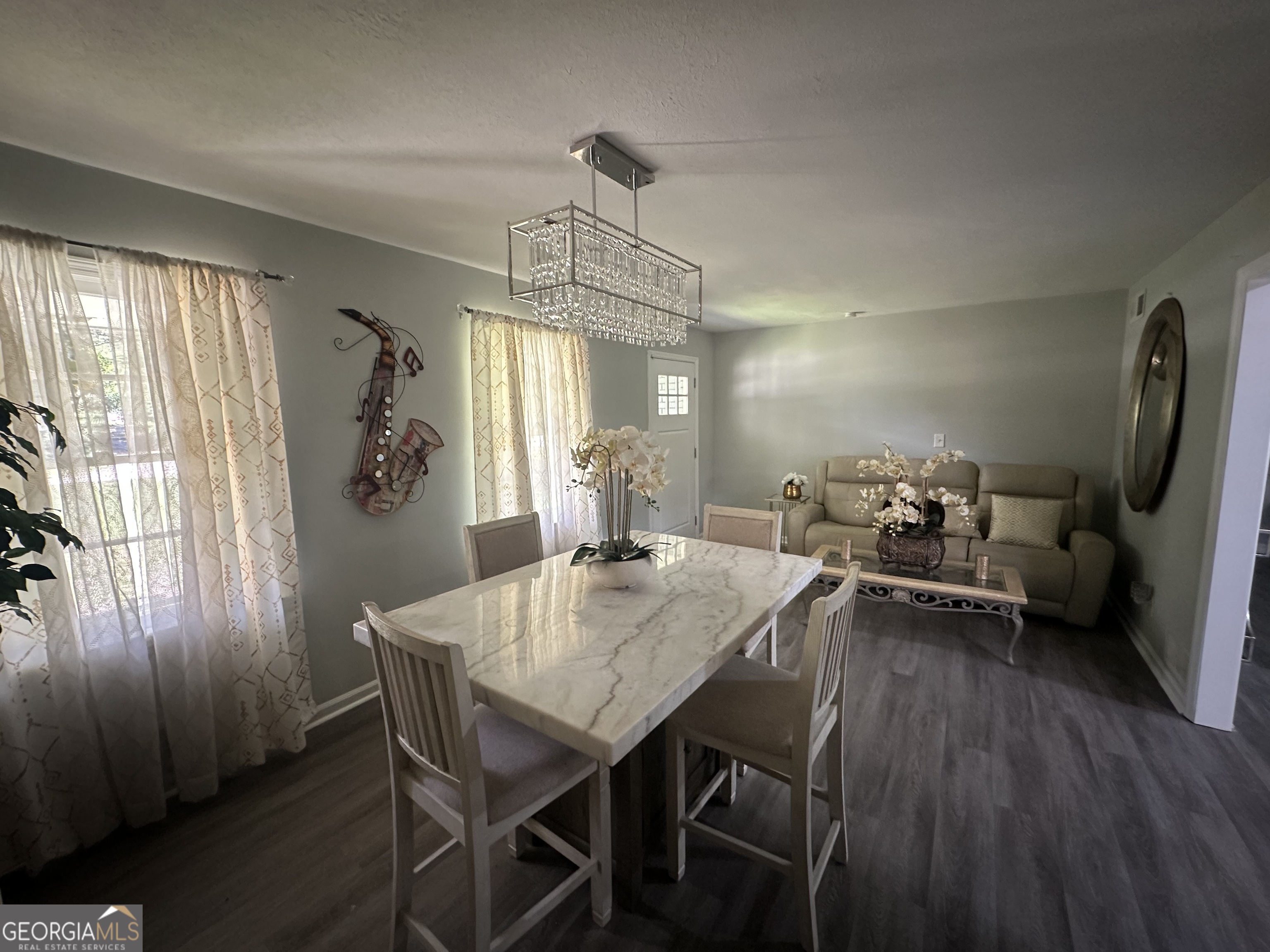 7383 Pleasant Hill Road Lithonia, GA 30058 - Photo 10 of 18 a view of a dining room with furniture window and wooden floor