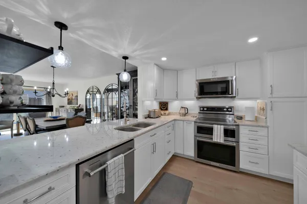 a kitchen with refrigerator and cabinets