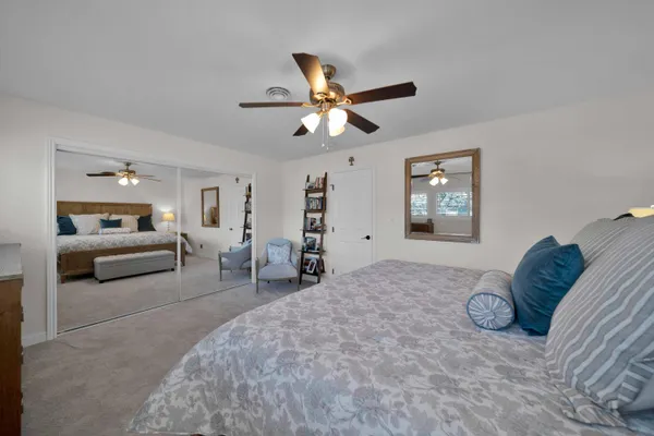 a bedroom with a bed and a couch