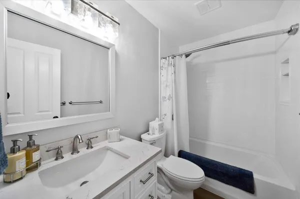 a bedroom with a large bed and a flat screen tv