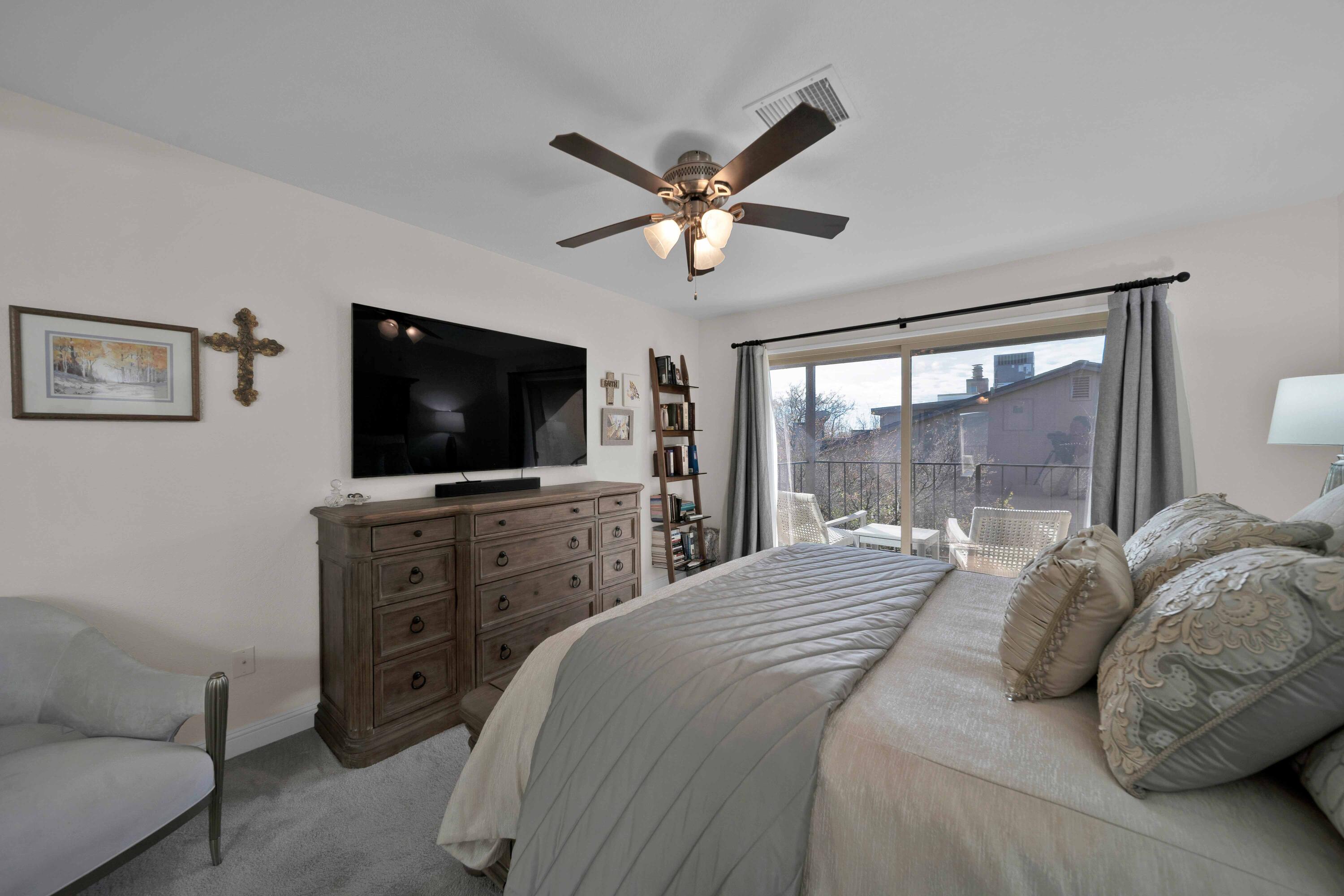1928 Bechelli Lane Redding, CA 96002 - Photo 35 of 62 a bedroom with a large bed and a flat screen tv