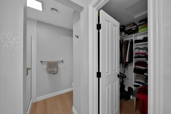 a view of a backyard with large trees and wooden fence