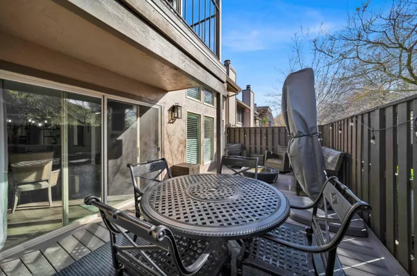 a backyard of a house with fountain table and chairs