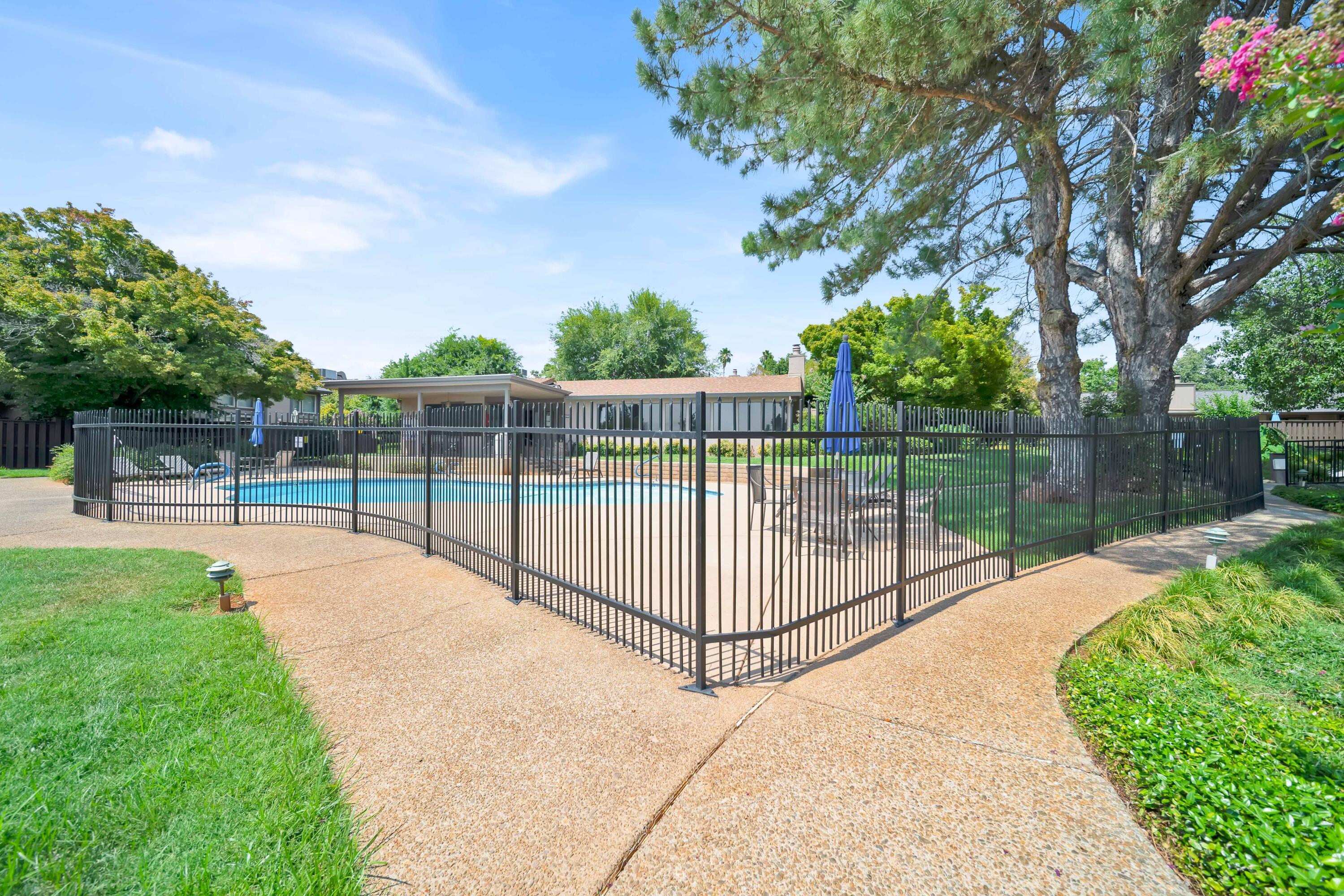 1928 Bechelli Lane Redding, CA 96002 - Photo 53 of 62 a view of a backyard with large trees and wooden fence