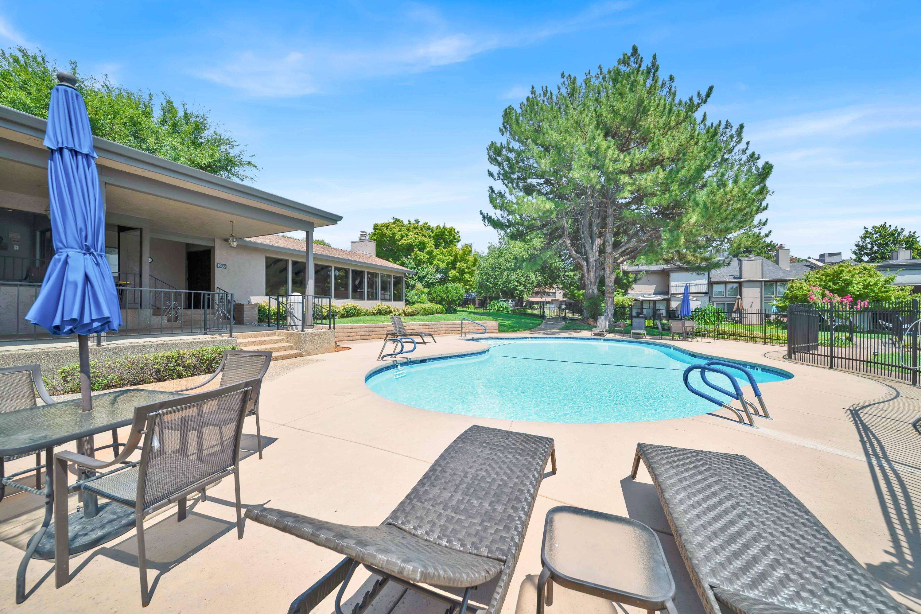 1928 Bechelli Lane Redding, CA 96002 - Photo 54 of 62 a swimming pool with outdoor seating and yard
