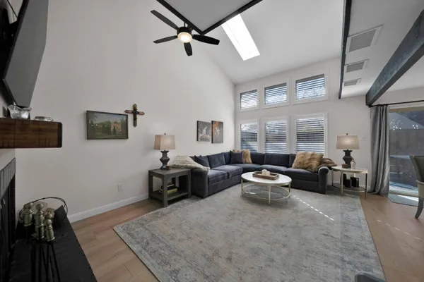 a living room with furniture a fireplace and a flat screen tv