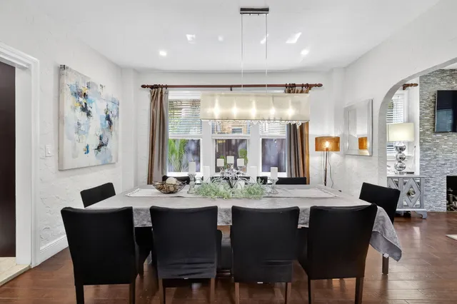 a kitchen with stainless steel appliances kitchen island granite countertop a refrigerator and a stove top oven