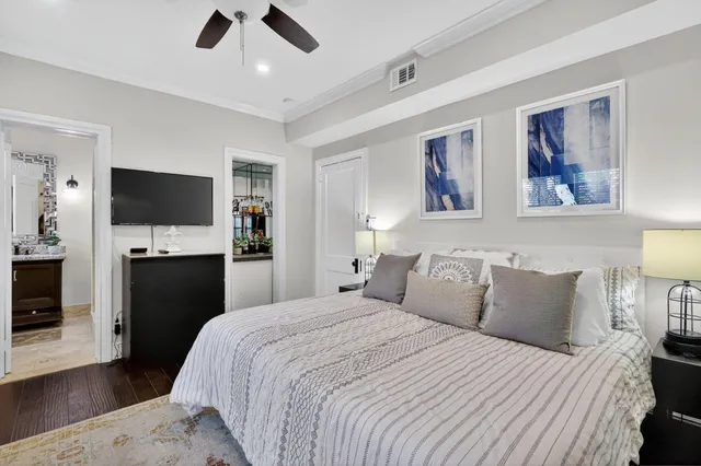 a bedroom with a bed wooden floor and window