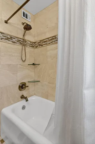 a bedroom with a bed and a flat screen television