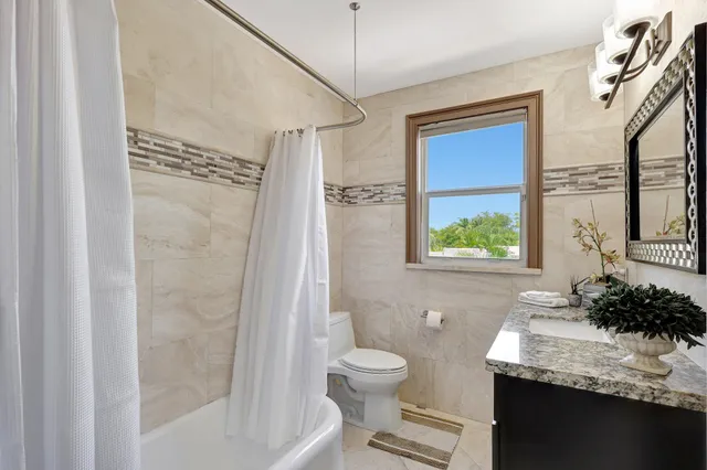 a view of a patio with table and chairs and potted plants