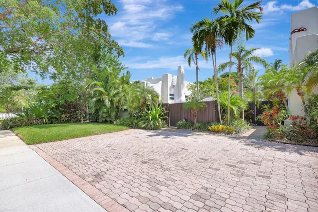 an aerial view of a city with lots of residential buildings and ocean view in back
