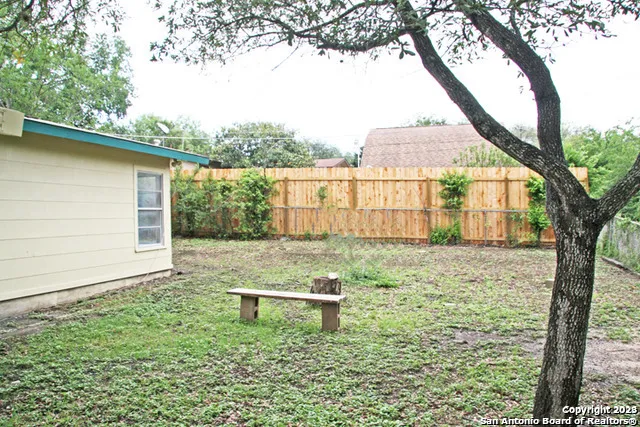 a backyard of a house with lots of green space and fountain