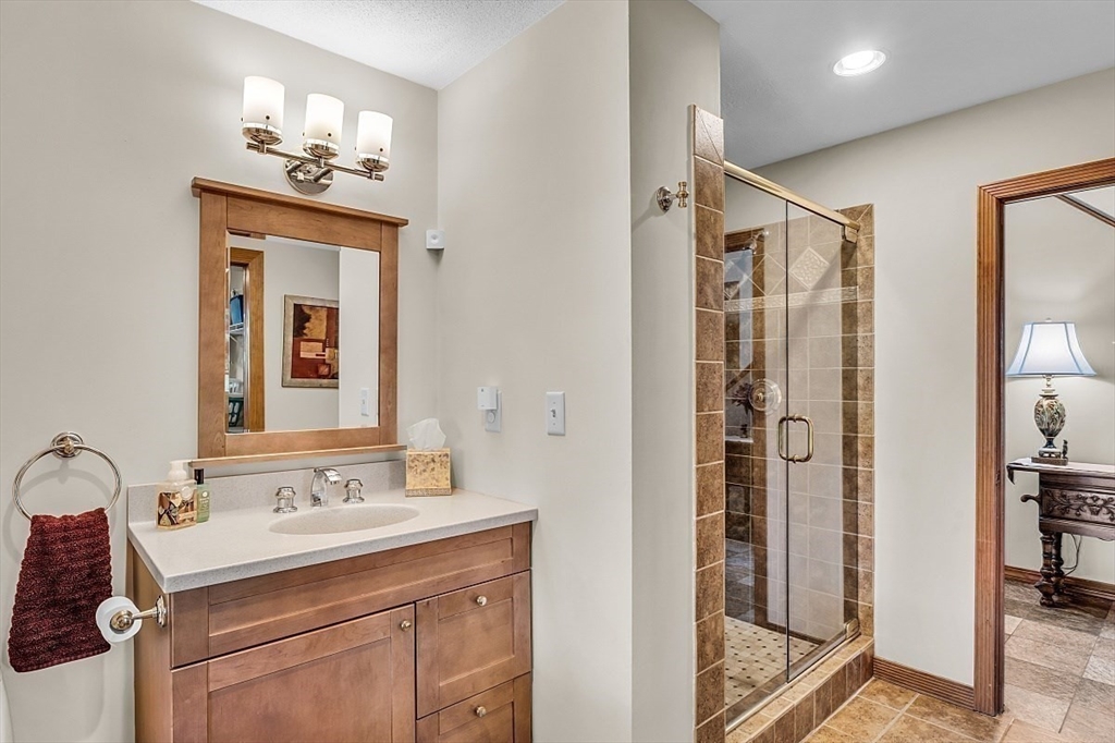 17 Berkshire Road Peabody, MA 01960 - Photo 21 of 41 a bathroom with a shower sink and mirror