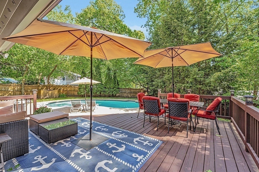 17 Berkshire Road Peabody, MA 01960 - Photo 37 of 41 a view of a roof deck with table and chairs under an umbrella