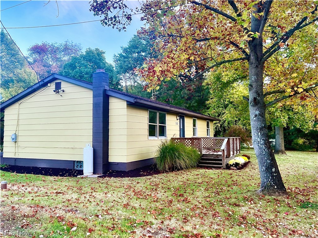 3122 Bedrock Road Northwest Dellroy, OH 44620 - Photo 7 of 23 View of home's exterior featuring a lawn and a deck