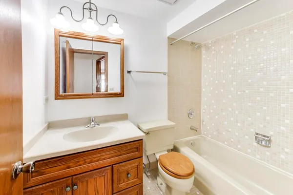 a bathroom with a sink a toilet and bathtub