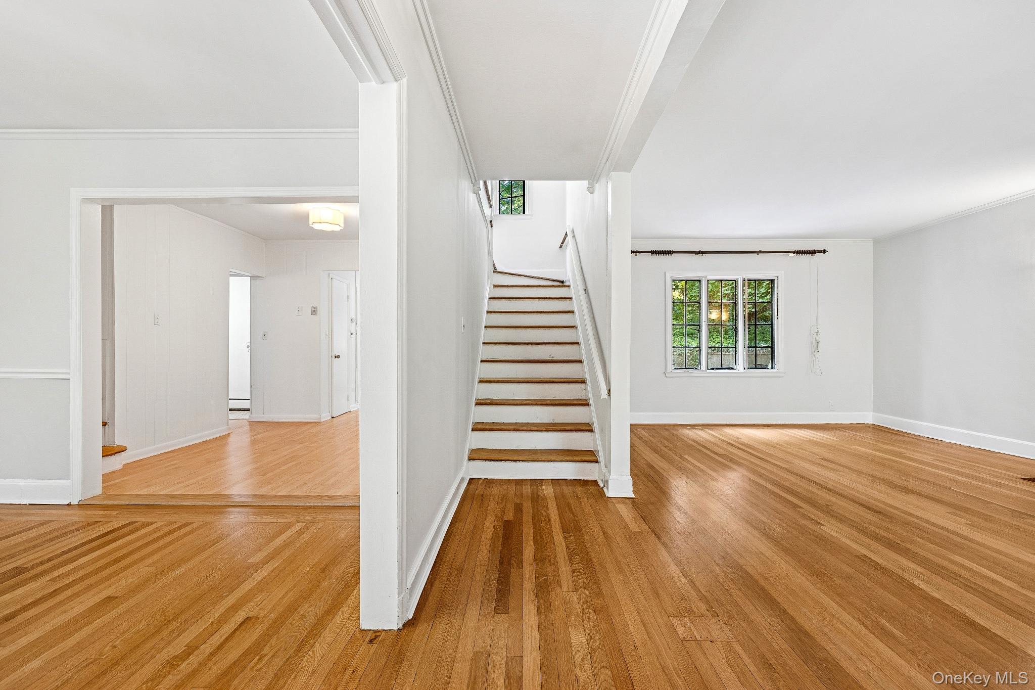 10 River Road Scarsdale, NY 10583 - Photo 3 of 20 Stairway featuring wood finished floors and crown molding