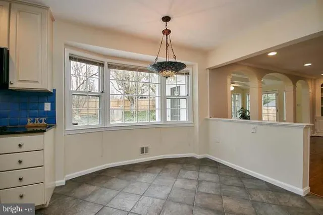 a view of a kitchen with cabinet and windows