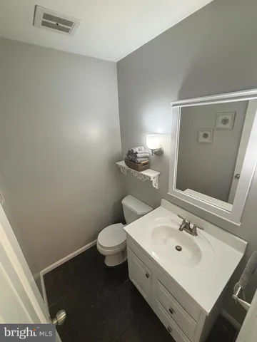 a bathroom with a sink toilet and mirror