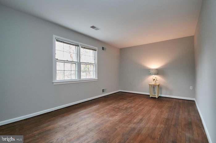 1006 Kimberwicke Road McLean, VA 22102 - Photo 25 of 42 an empty room with wooden floor cabinet and windows