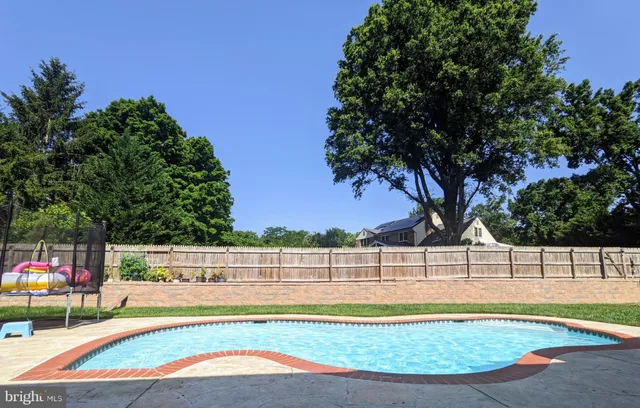 a view of yard with swimming pool and seating