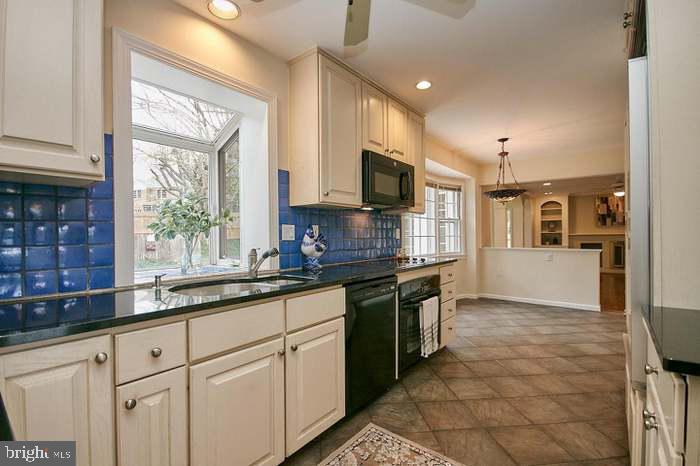 1006 Kimberwicke Road McLean, VA 22102 - Photo 9 of 42 a kitchen with stainless steel appliances granite countertop a stove a sink and a microwave