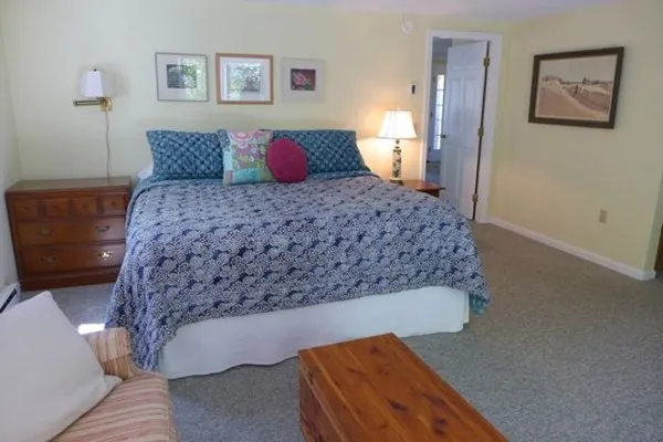 a bedroom with a large bed and a couch