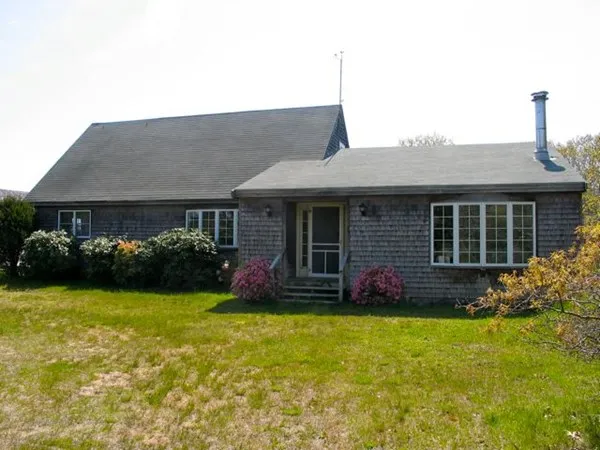 a front view of house with yard and green space
