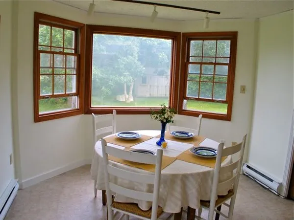 a dining room with furniture and window