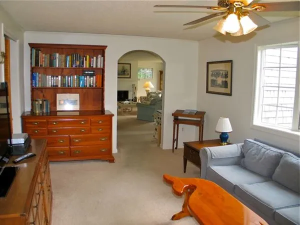 a living room with furniture a large window and a fireplace
