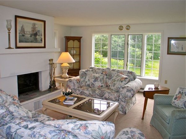 20 Katama Bay Road Edgartown, MA 02539 - Photo 27 of 40 a living room with furniture a large window and a fireplace