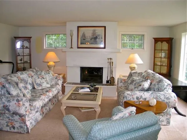 a bedroom with a bed and two windows