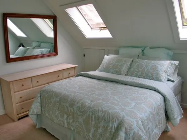 a bedroom with two beds and a window