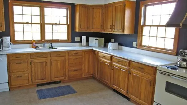 a view of a house with swimming pool next to a yard