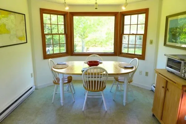 a dining room with furniture and window