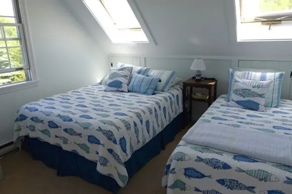 a bedroom with bed and window