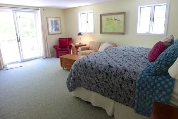 a bed sitting in a bedroom next to a window