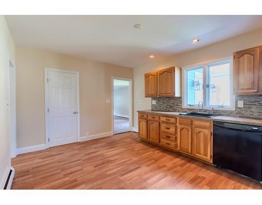 142 East Meadow Road Lowell, MA 01854 - Photo 11 of 28 a kitchen with granite countertop a sink cabinets and wooden floor