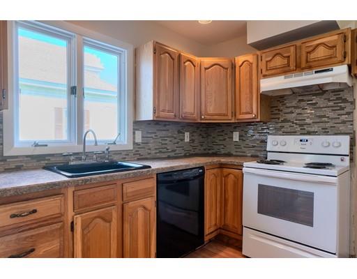 142 East Meadow Road Lowell, MA 01854 - Photo 13 of 28 a kitchen with stainless steel appliances granite countertop a stove a sink and a microwave